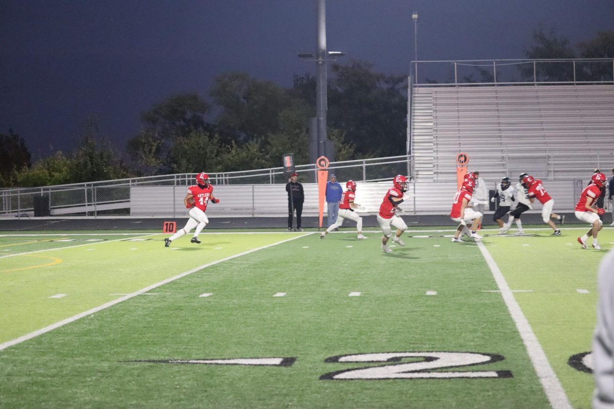 Sophomore, Trey Pacas, running down the field with the ball.