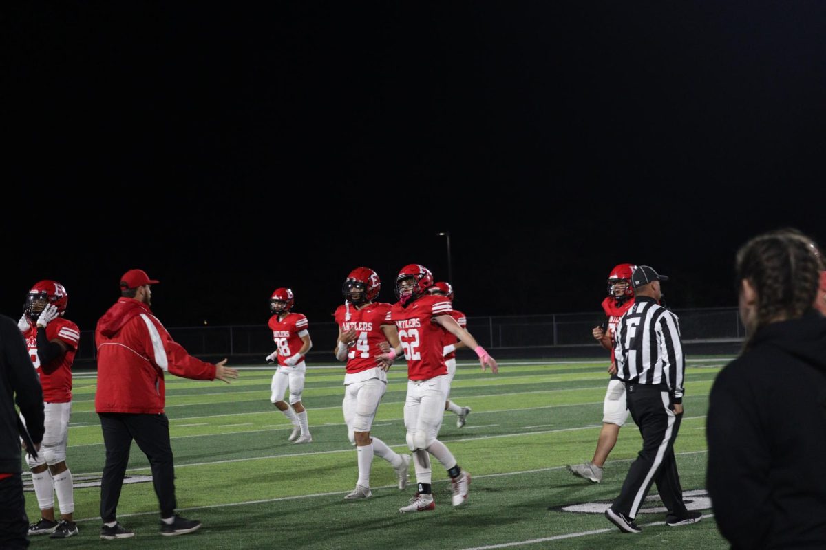 Sophomore, Tucker Tollefson, celebrating with his coach after a play. 