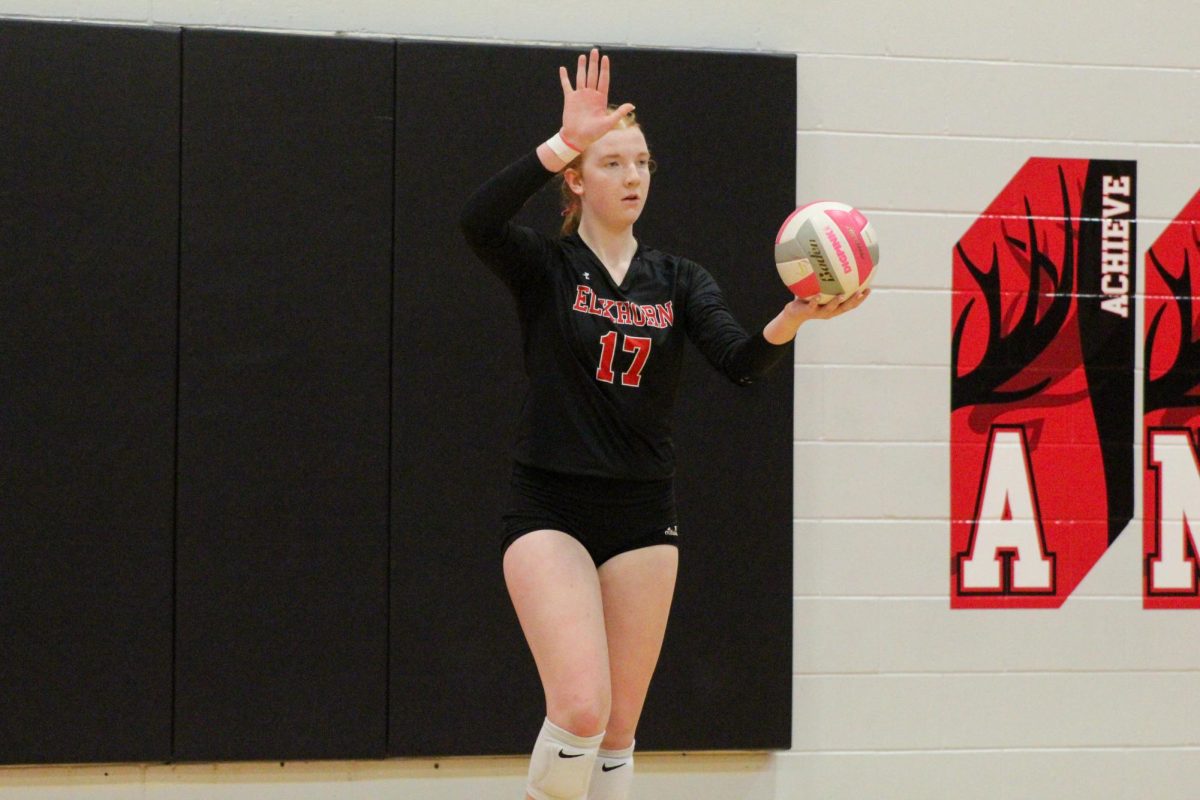 Freshman Kelsie Holder aims her arm to get a good serve. This game took place on 10/3, and the Antlers lost to Bellevue East 2-1.