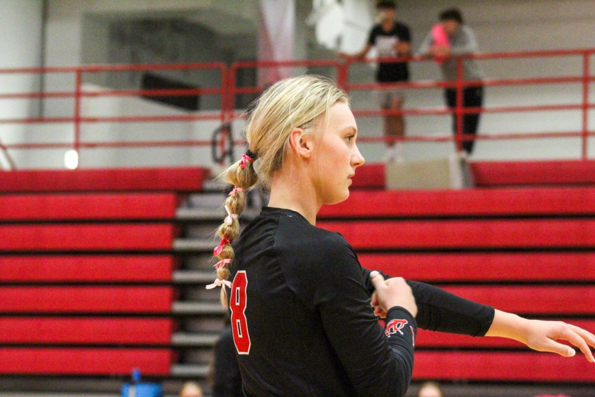 Sophomore Charley Weeder rolls her sleeves up in between plays. This game took place on 10/3, and the Antlers lost to Bellevue East 2-1.