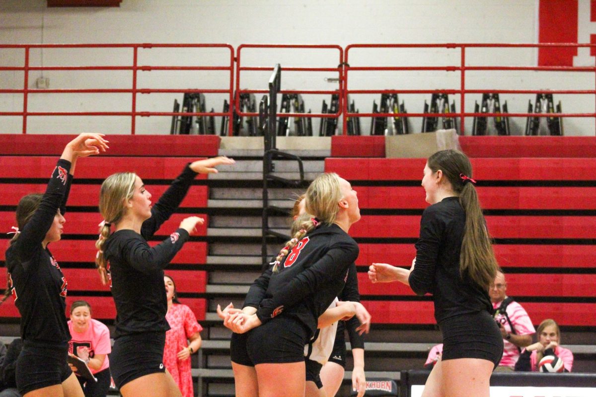 Sophomore Callie Petersen gets hyped up by her teammates. This game took place on 10/3, and the Antlers lost to Bellevue East 2-1.