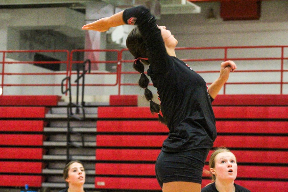 Sophomore Kaiya Gilbert reaches back to hit the ball. This game took place on 10/3, and the Antlers lost to Bellevue East 2-1.