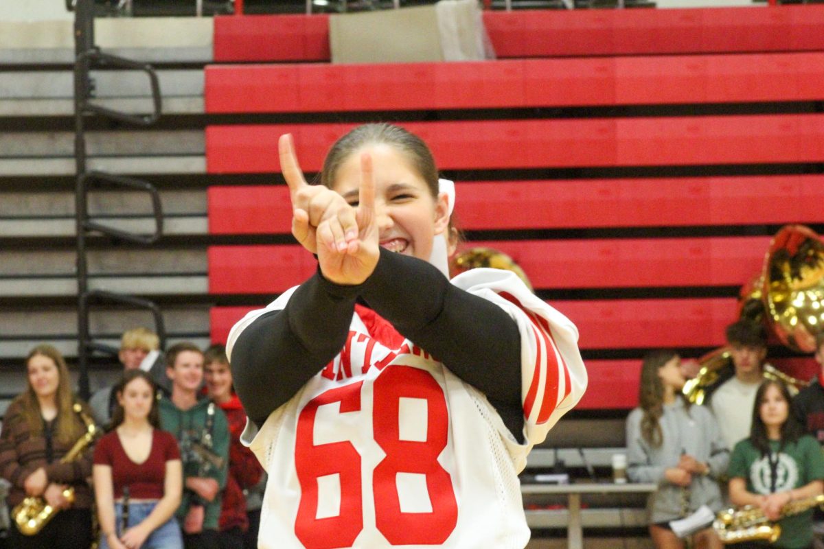 Junior Evelyn Wutzke smiles big during her routine. This took place during the Homecoming pep rally on Friday the 4th.