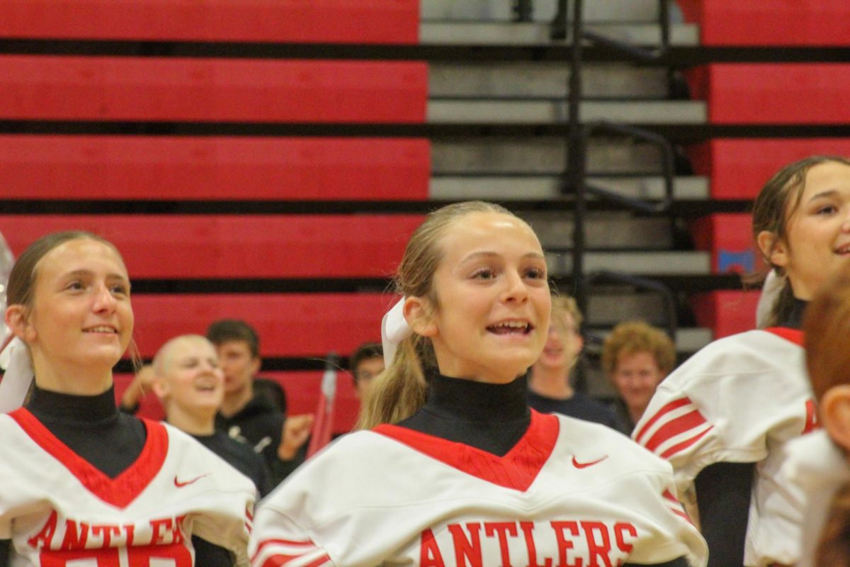 Sophomore Jillian Narber smiles as she cheers. This took place during the Homecoming pep rally on Friday the 4th.