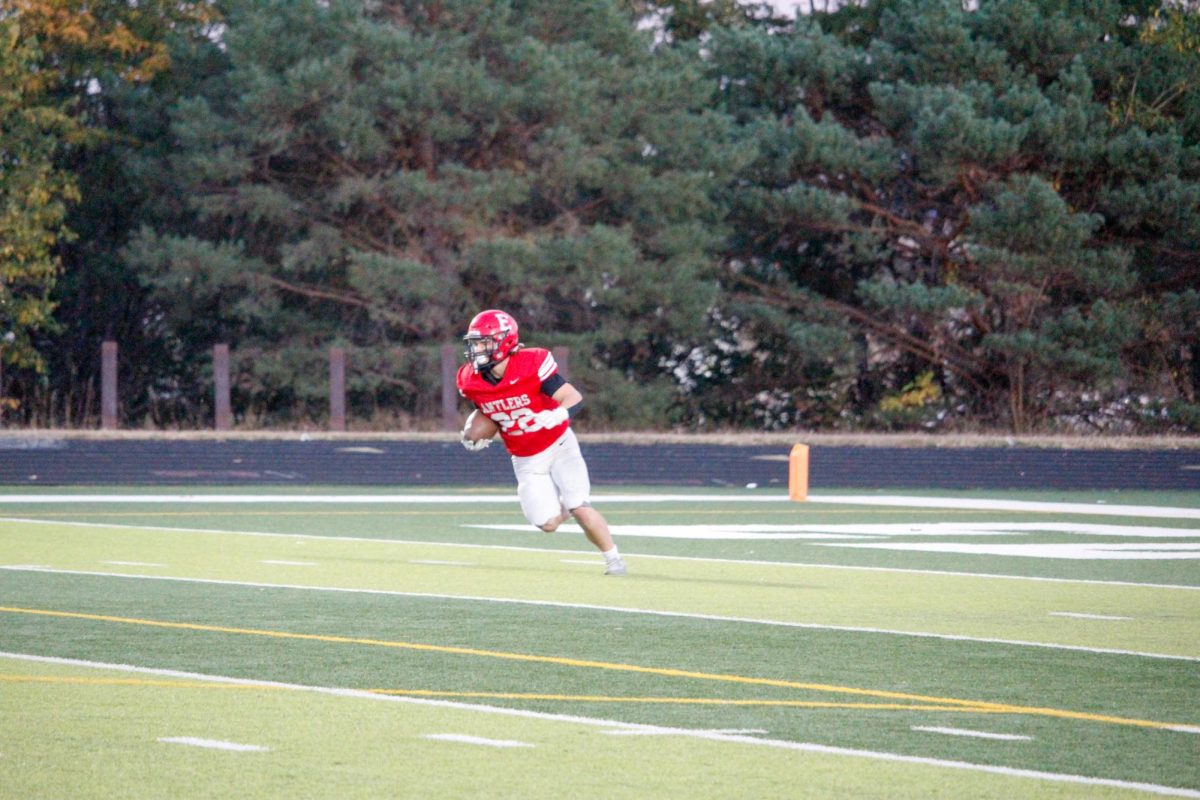 Sophomore Wyatt Worlie runs the ball down the field. JV football plays North, final score ending 13-33.