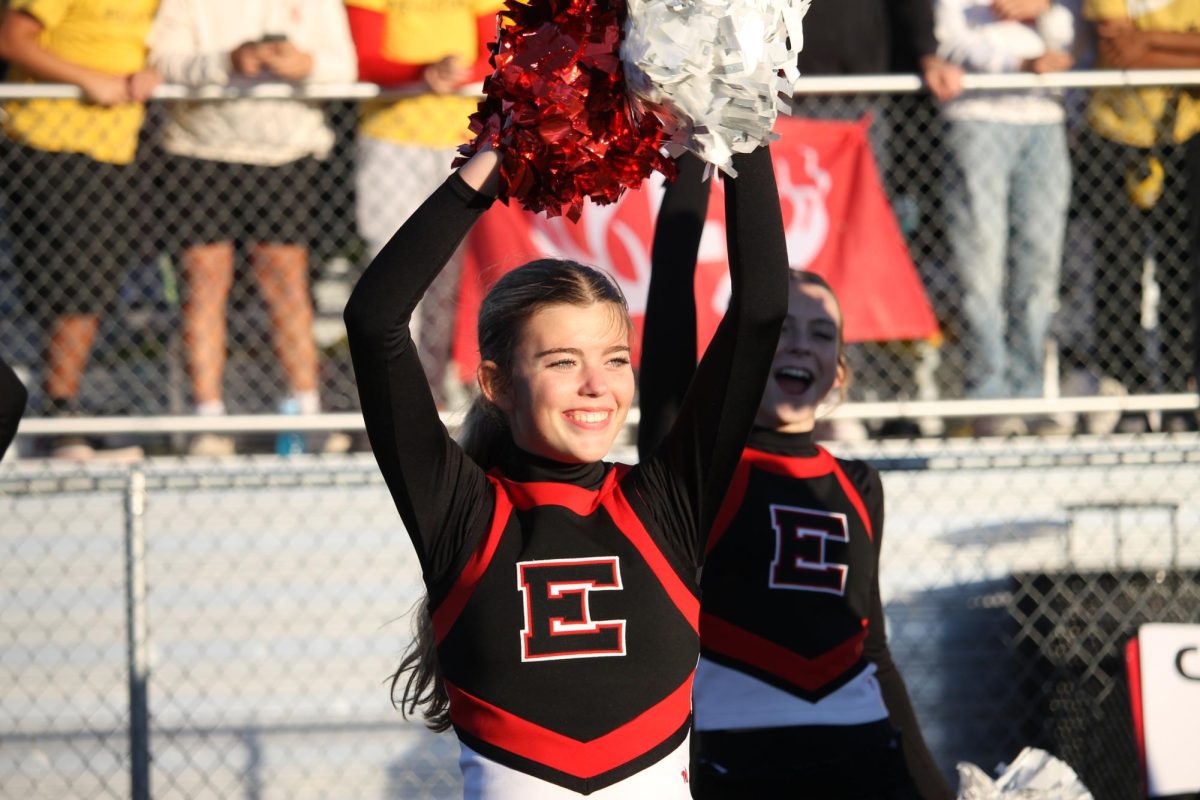 Sophmore Ava Cook cheers loud for Elkhorn High's football team against Elkhorn North.