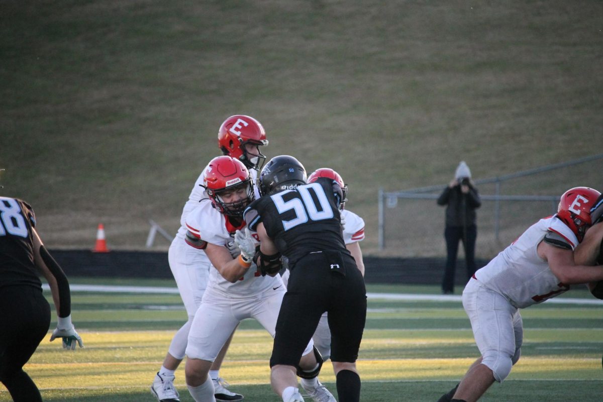 Senior Charlie Lampski blocks number 50 on Elkhorn North to help out his quarterback senior Kayd Matthews.