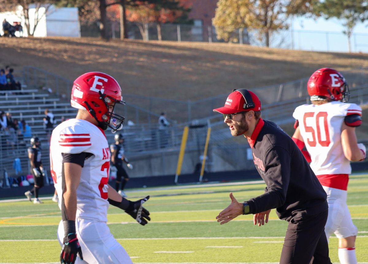 Coach Feickert congratulates Gus Schultz after a good play. The Antlers faced Elkhorn North with a final score of 14-35 in the first round of playoffs.