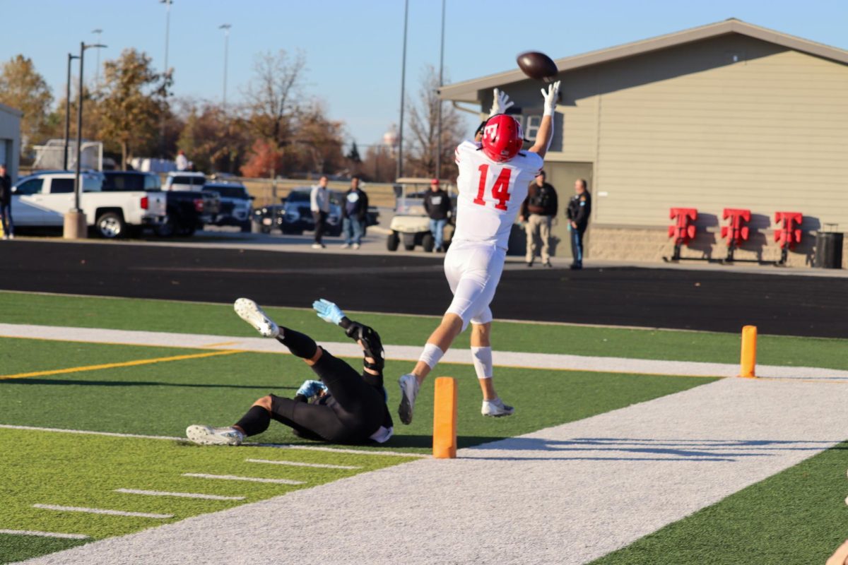 Senior Peyton Turman attempts to catch the ball in the enzone. The Antlers faced Elkhorn North with a final score of 14-35 in the first round of playoffs.