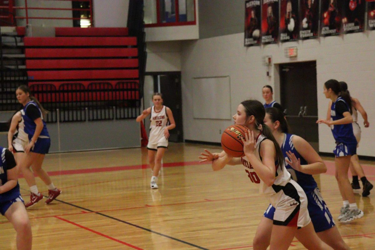 Freshman, Avery Eicher, passing the ball to her teammate.