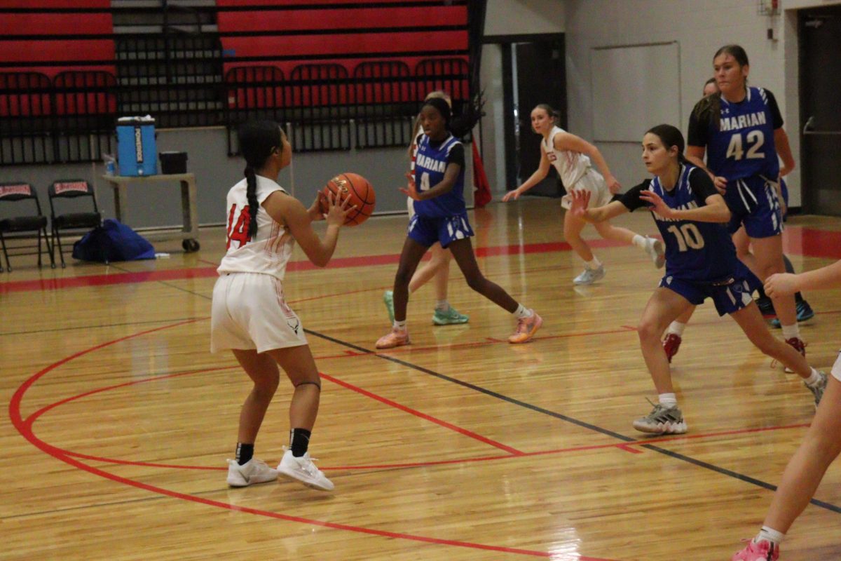 Sophomore, Azaria Melcher, shooting the ball.