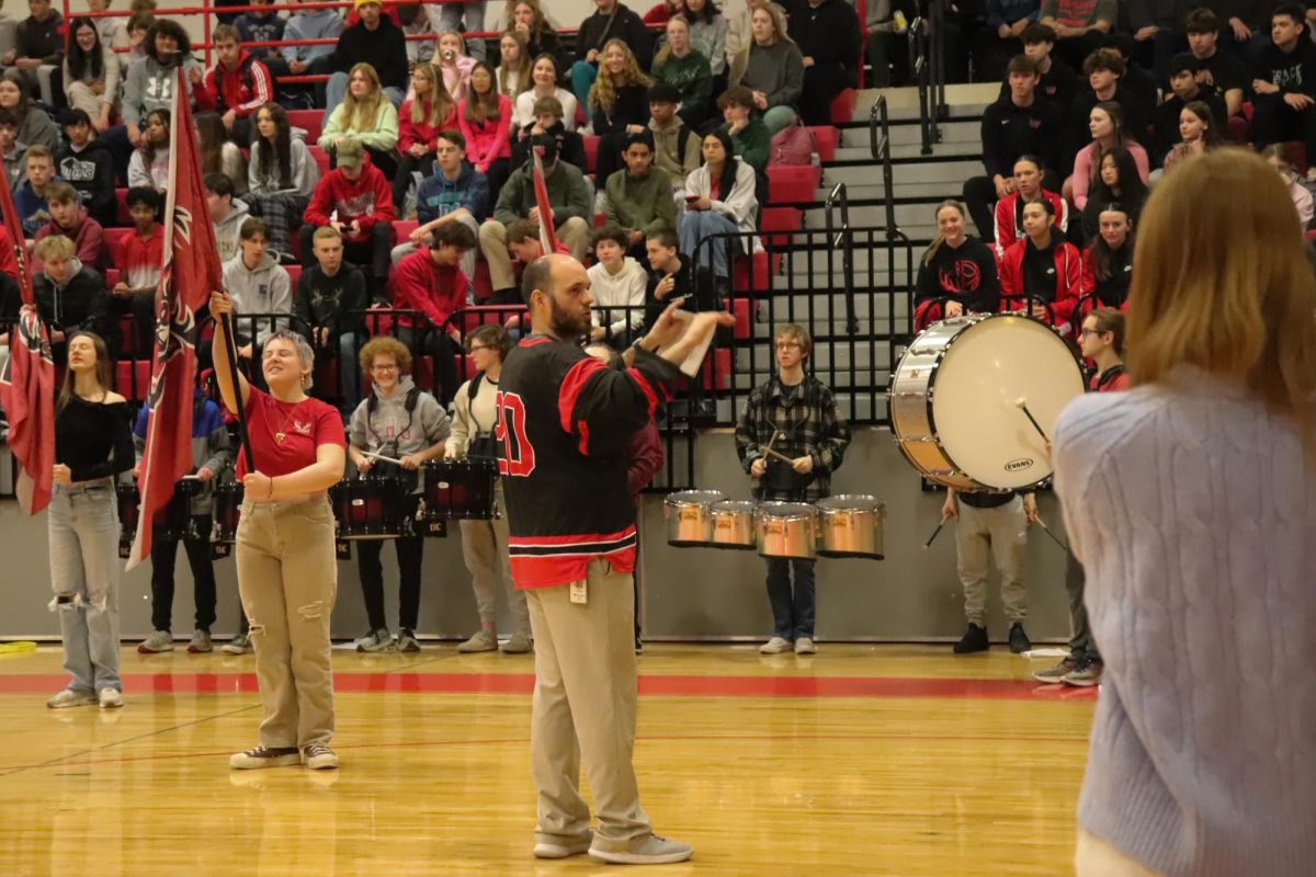 Band Director Kyle Dreessen leads his band during the pep rally on January 17, 2025.