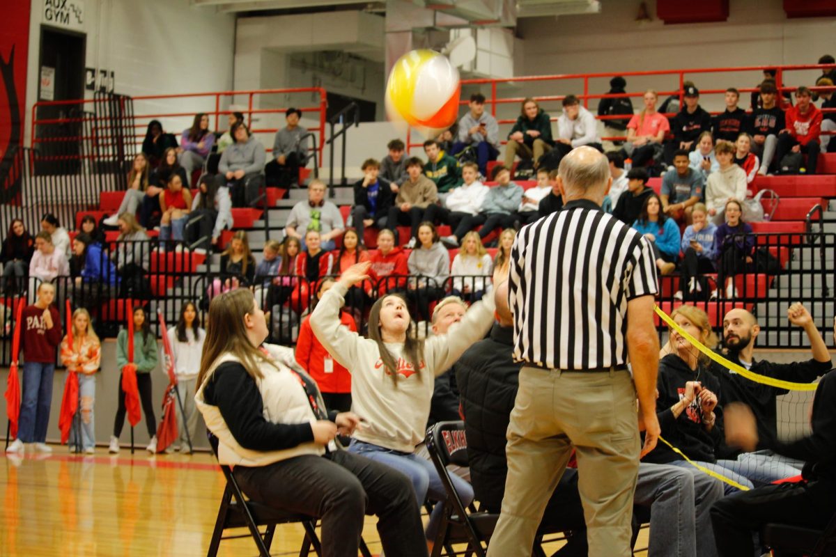 Ms. pravecek serving the ball to the students for the intense game of seated volleyball. this happened on January 17th at the winter pep rally.