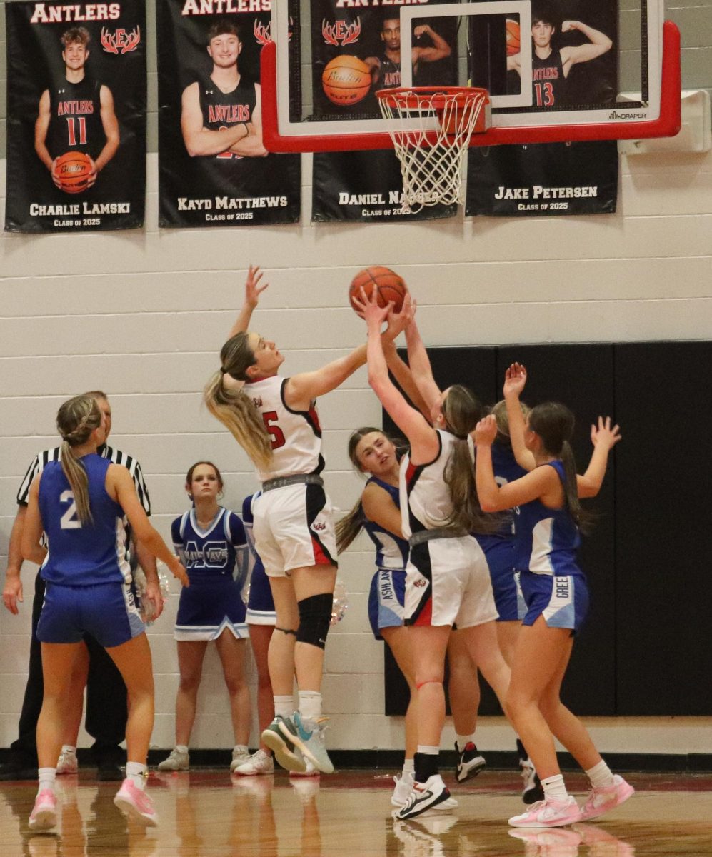 Senior, Addison Hunt fights for the ball back.