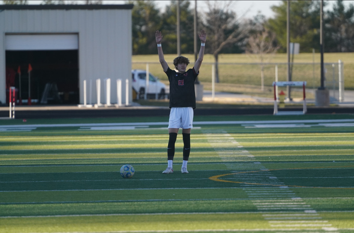 Senior Caleb Kimmel takes free kick for the Antlers. 