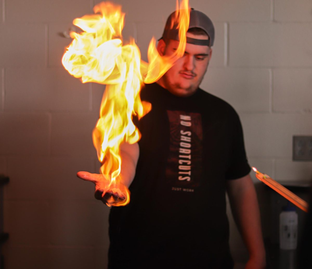 Junior Timothy Stoddard reacts nonchalantly after his hand is lit on fire. This took place in Mr. Stednitz's 5th hour chemistry class.