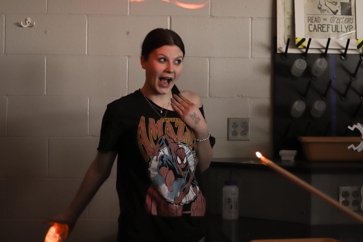 Junior McKenzie Cook reacts after her hand is lit on fire. This took place in Mr. Stednitz's 5th hour chemistry class.