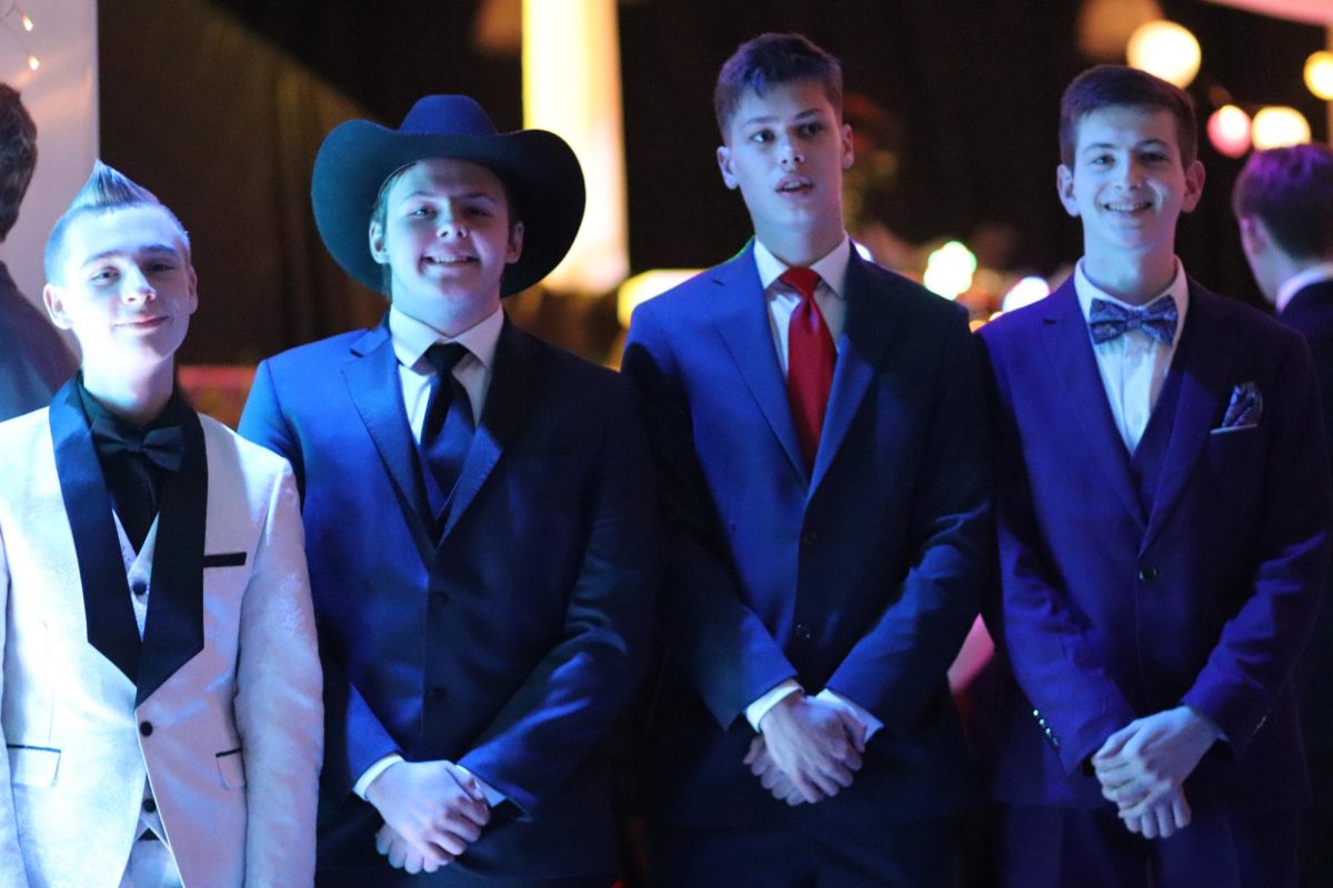 Junior boys pose while at prom.
