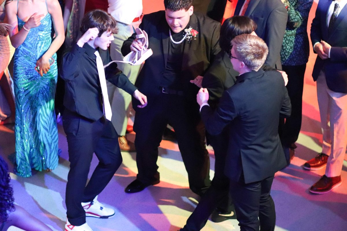 Senior boys dance to songs while at prom.