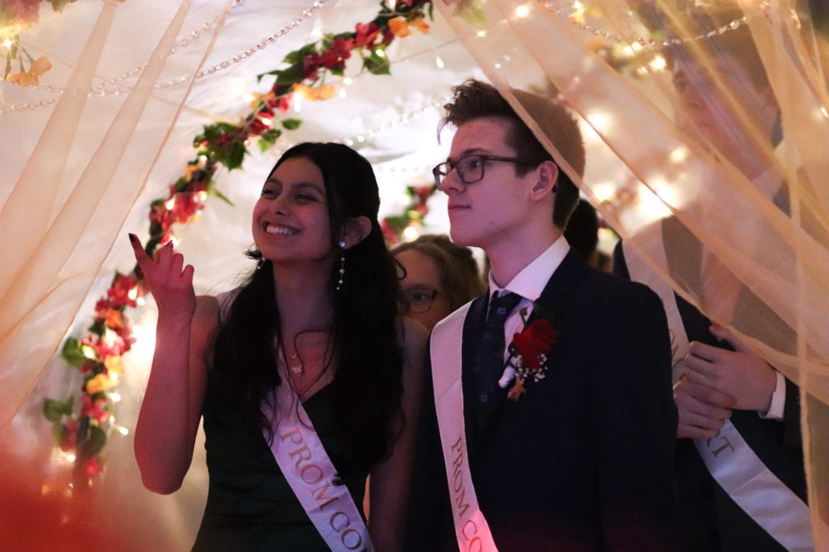 Junior court Princess, Yuridia Hernandez, and Junior, Carson Deprez walking towards the stage for coronation.