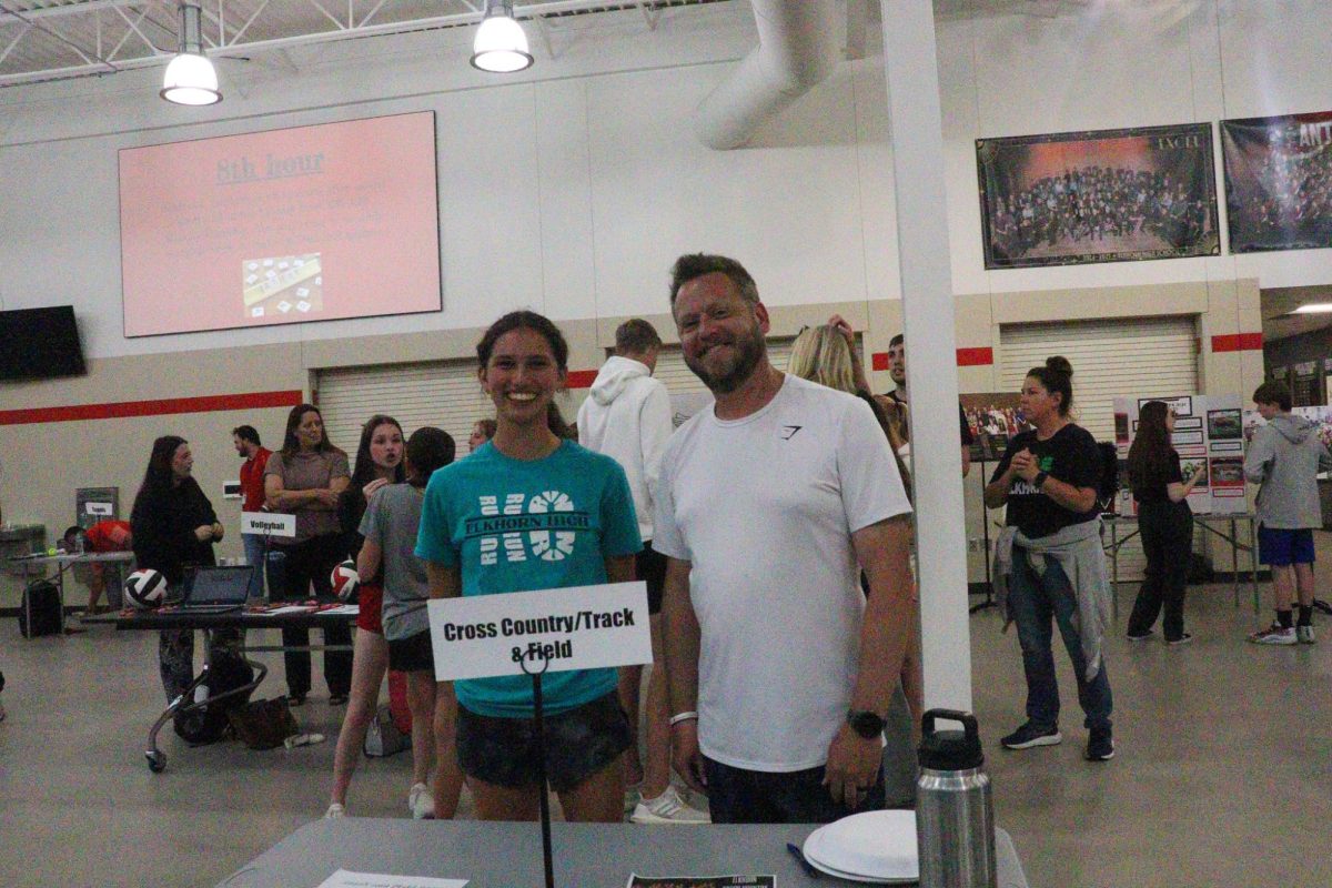 Coach Stednitz and junior Paige Whitebear run the table for cross county and track at 8th grade orientation