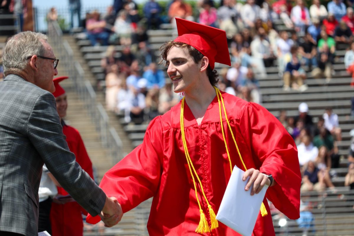 Timothy Boomgarden shakes hands with Mark Wortman after receiving his diploma. Graduation was held May 18th.