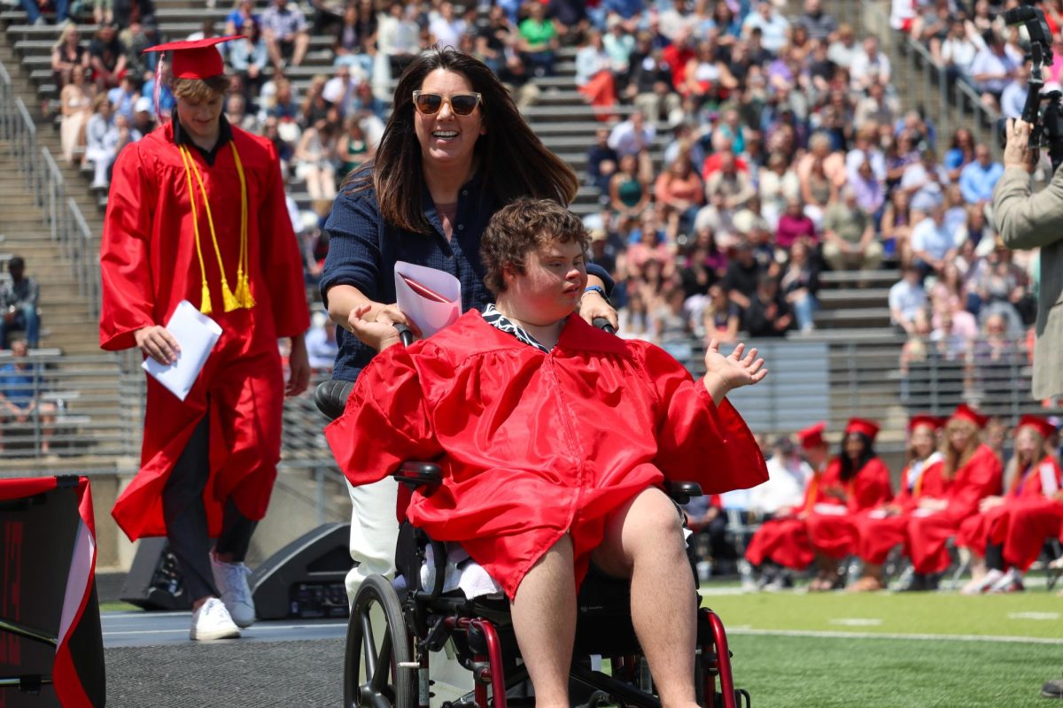 Courtney Larsen and Brady Dahl smiles after receiving Dahl's diploma. Graduation was held May 18th.