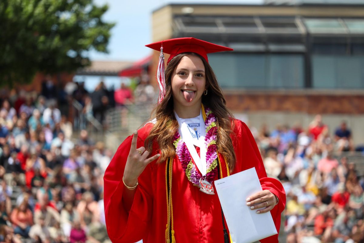 Sara Ott holds up "Antlers Up" as she walks off the stage. Graduation was held May 18th.