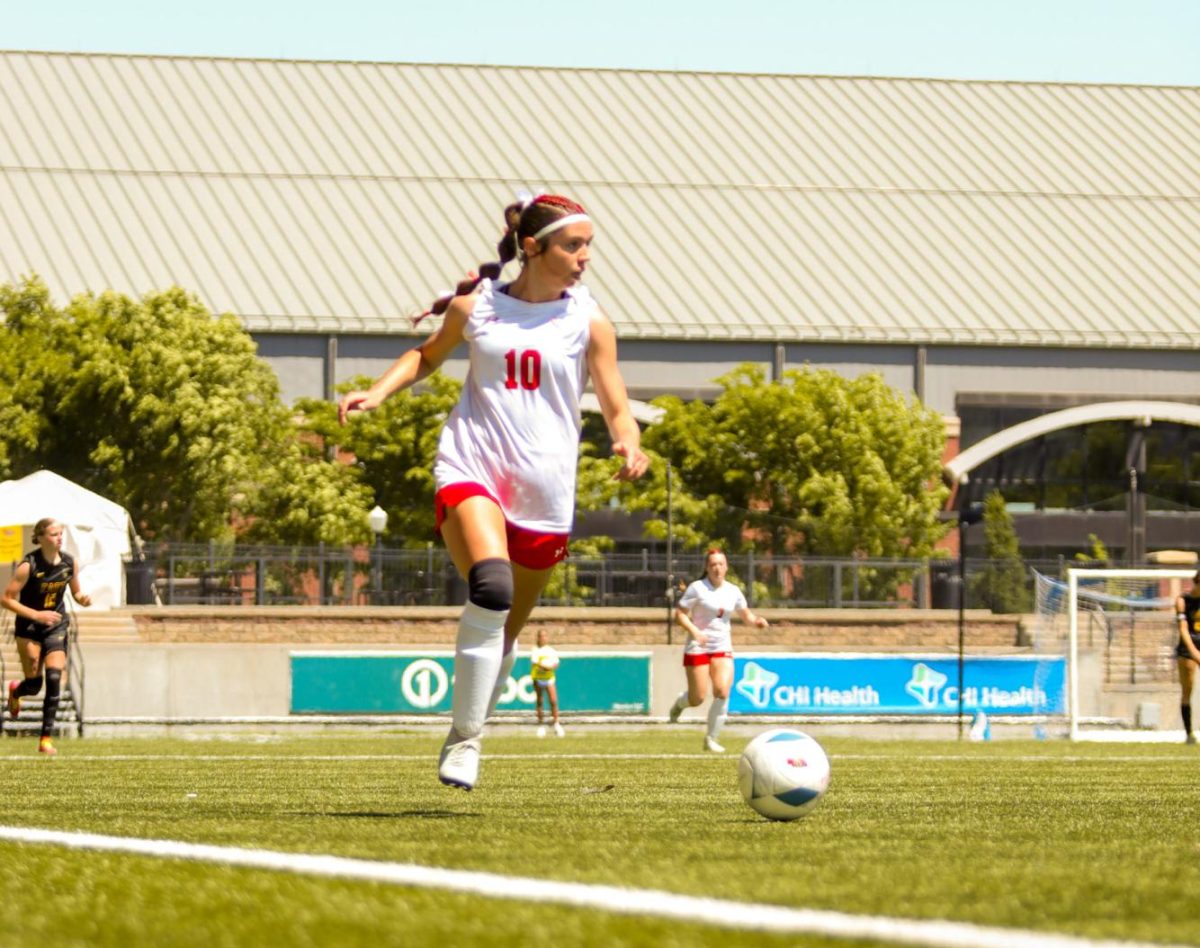 Sophomore Molly Flynn takes the ball upfield during the state soccer game. The Antlers lost at state 6-2 to Gretna East.