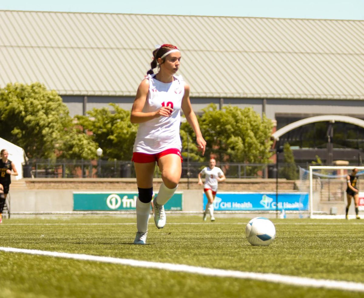 Sophomore Molly Flynn dribbles the ball up the field during the state soccer game. The Antlers lost at state 6-2 to Gretna East.