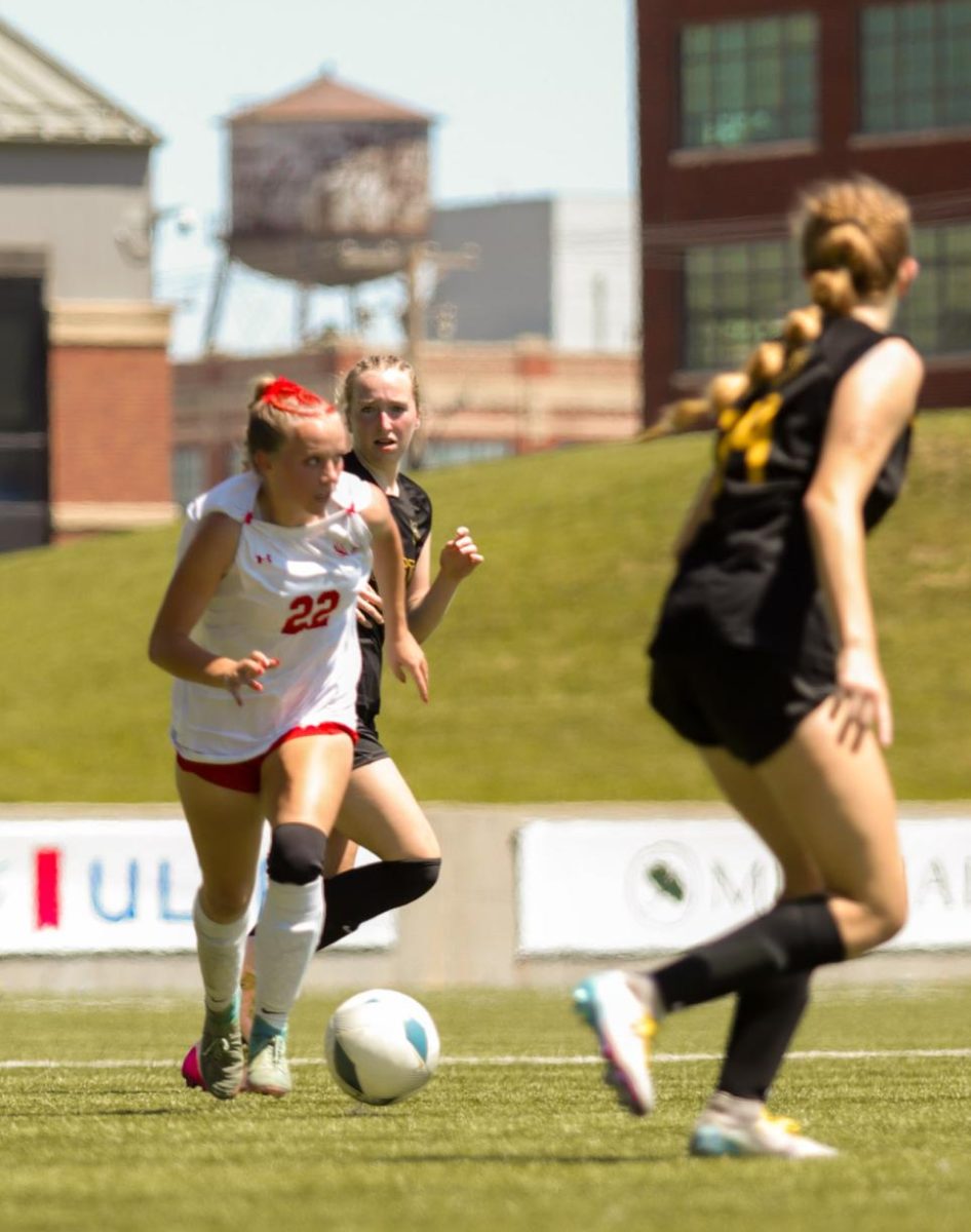 Junior Olivia Thompson dribbles between two Griffin defenders. The Antlers lost at state 6-2 to Gretna East.