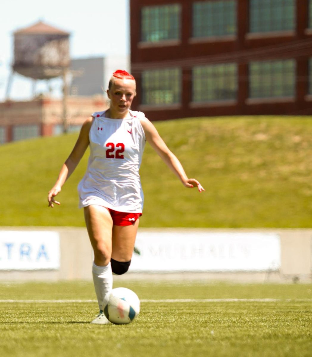 Junior Olivia Thompson moves the ball upfield during the state soccer game.