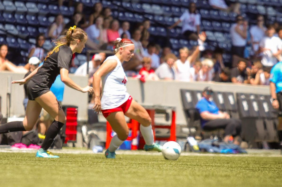 Senior Adriana Pagan dribbles around a defender. The Antlers lost at state 6-2 to Gretna East.
