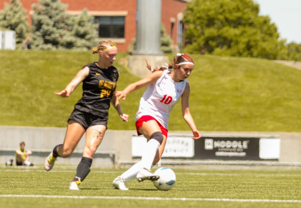 Sophomore Molly Flynn dribbles around a Griffin defender during the state soccer game. The Antlers lost at state 6-2 to Gretna East.