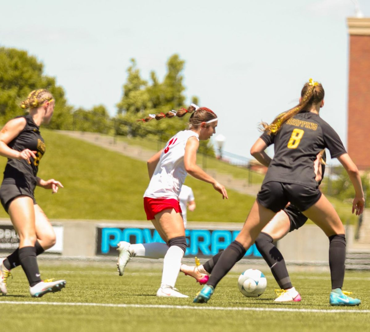Sophomore Molly Flynn dribbles around three Griffin defenders. The Antlers lost at state 6-2 to Gretna East.