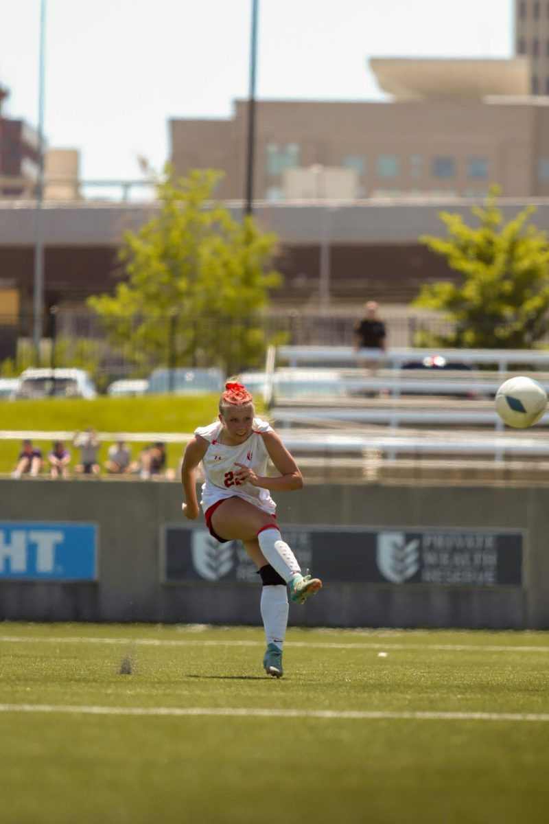 Junior Olivia Thompson passes the ball to a teammate during the state soccer game. The Antlers lost at state 6-2 to Gretna East.
