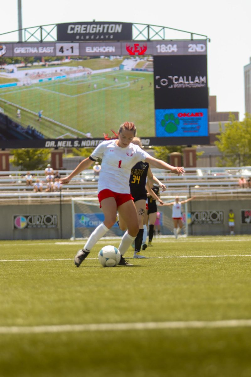 Junior Ella Rodgers dribbles the ball into the box during the state soccer game. The Antlers lost at state 6-2 to Gretna East.