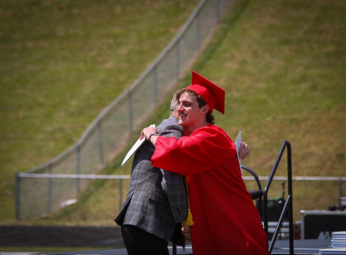 Timothy Boomgarden hugs Mark Wortman after receiving his diploma. Graduation was held May 18th.