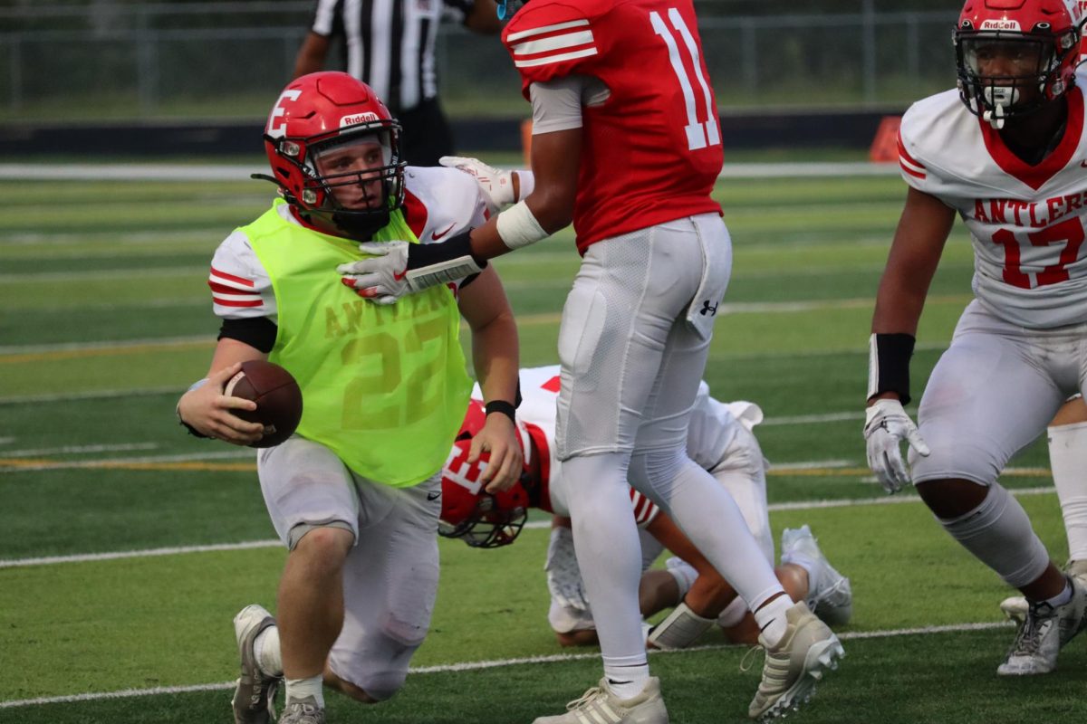 Wyatt Worlie runs with the ball and attempts to score at the red and white scrimmage on August 22nd.