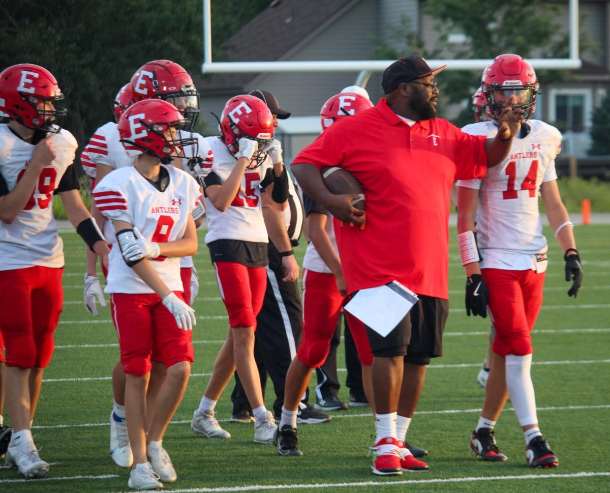 Coach Paul discusses the next play with his team. The Antlers played the Gretna Dragons on Thursday August 28th.