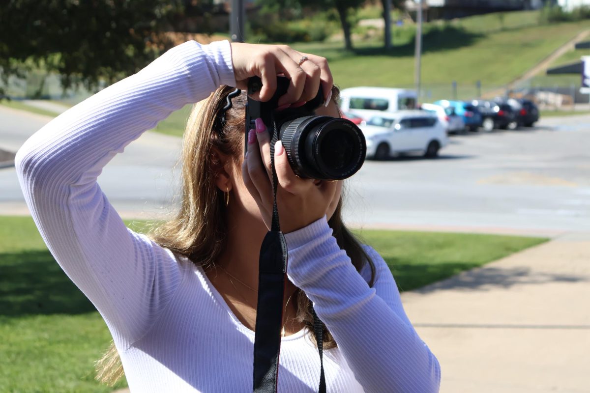 Heather Ramirez taking photos at the photography class