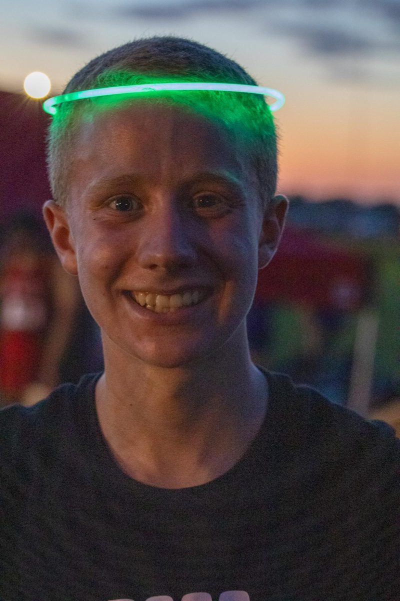 Sophomore Brenden Fisher posing at the Tiger Twilight XC meet in Freemont. The glowstick around his head was a highlight of the meet which was run in the dark under the lights.