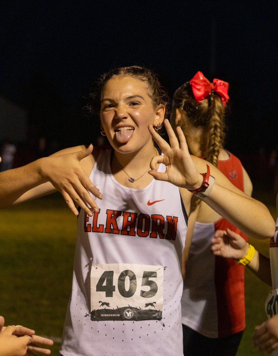 Sophomore Claire Asher posing at the start line of her JV 5k race at the Tiger Twilight XC meet. Asher would go on to finish the race with a time of 24:03.