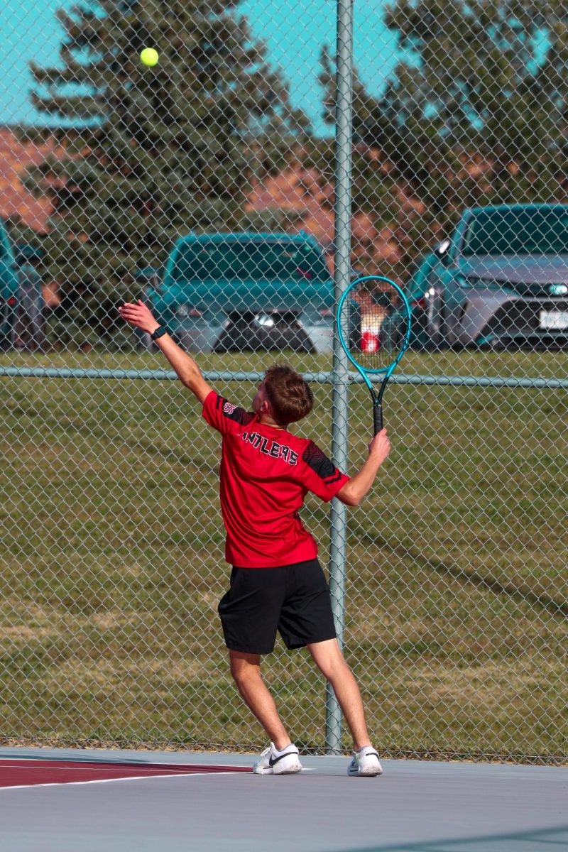 Junior Collin Pappas serving to his opponent from Mount Michael. 