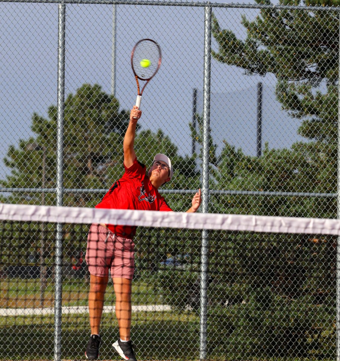 Junior Gavin Vasquez returning a hit from his opponent from Mount Michael during an intense rally.