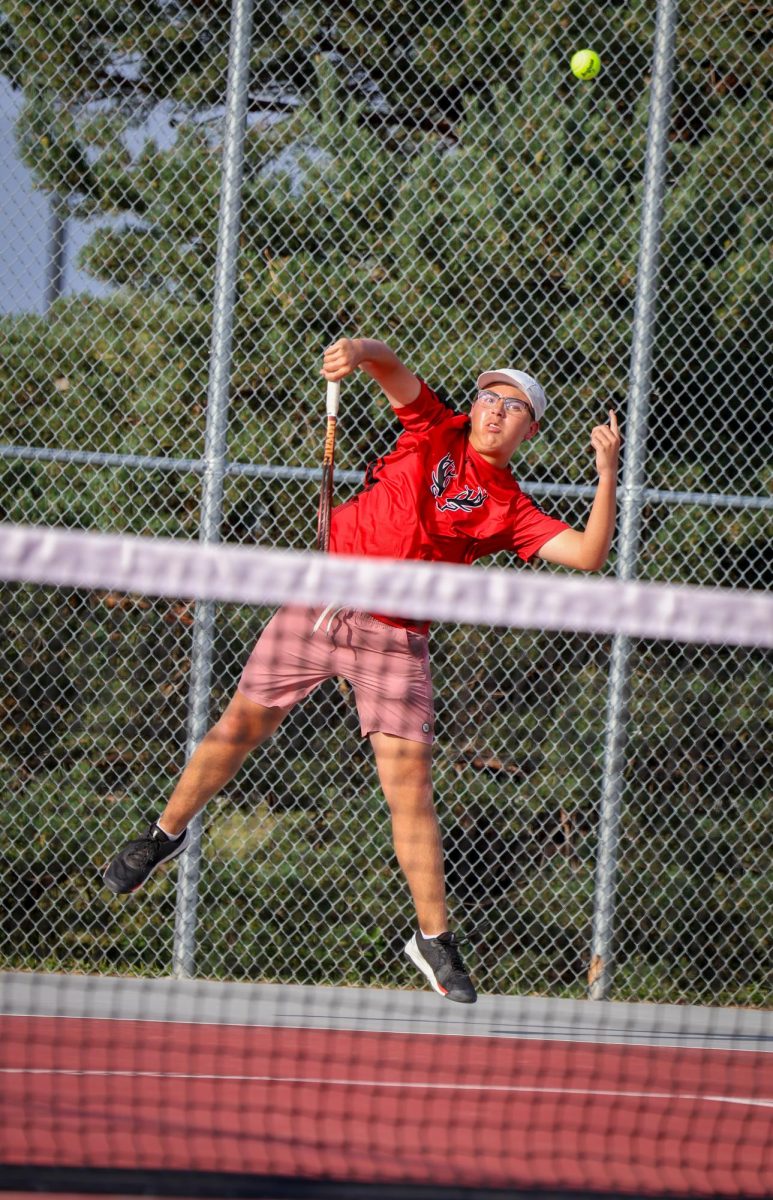 Junior Gavin Vasquez returns a shot from his Mt. Michael opponent during an intense rally.