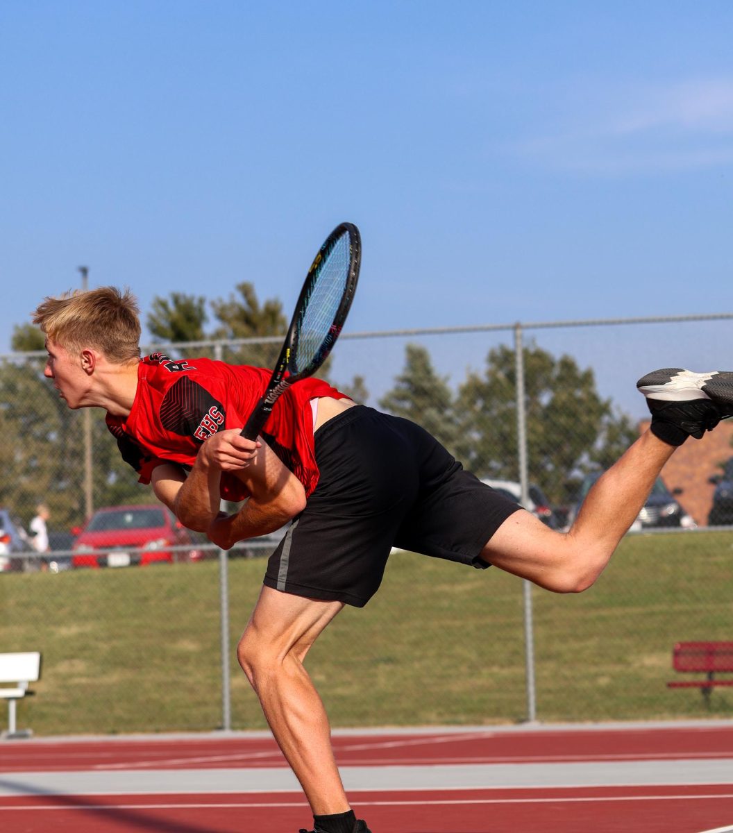 Sophomore Quintin Bretey serves to his opponent from Mount Michael.