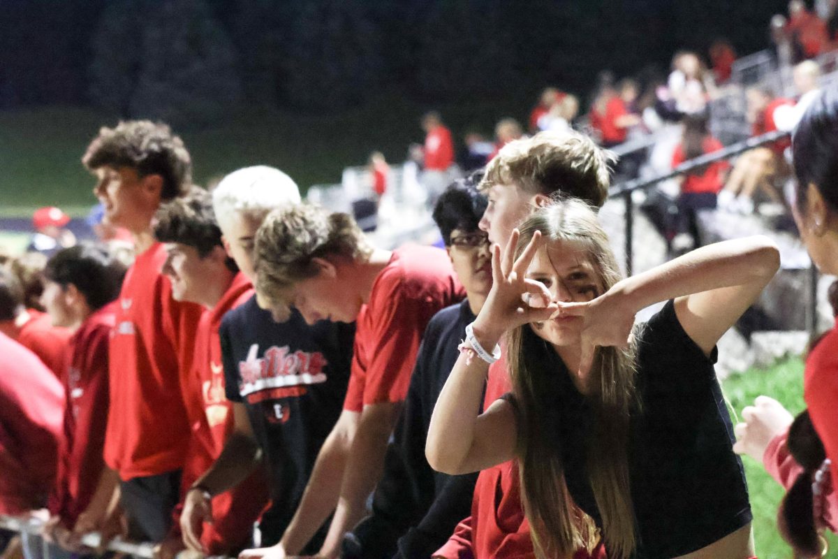 student section waiting for the football team to walk up the hill at homecoming game