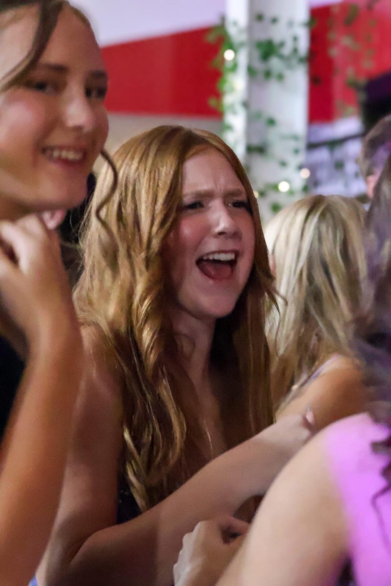 Junior Elodie Bunting dances and sings with friends during homecoming. Homecoming took place on Sept. 20th, 2025.