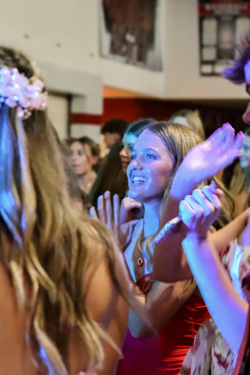 Freshman Olivia Martinie dances and sings with friends at homecoming. Homecoming took place on Sept. 20, 2025.